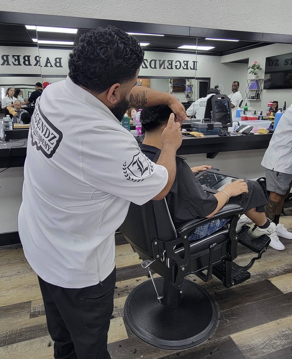 Barber finishing a fade
